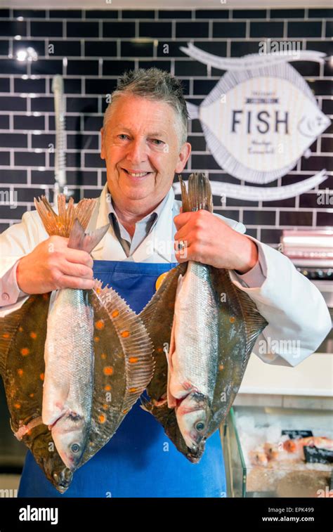 A Fishmonger At His Counter With Plaice And Sea Bass Uk Stock Photo Alamy