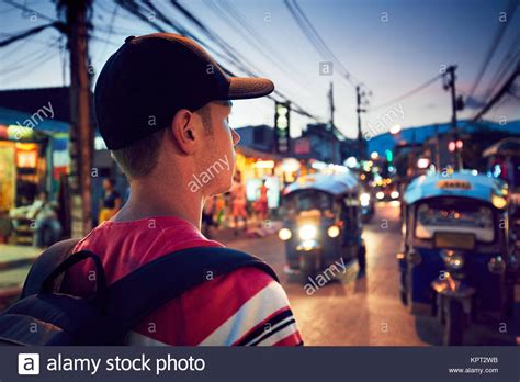 Young Man Walking On The Busy Street Full Of Shops Chiang Mai