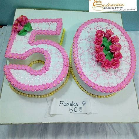 A White And Pink 50th Birthday Cake With Roses On The Number Fifty Two Sided