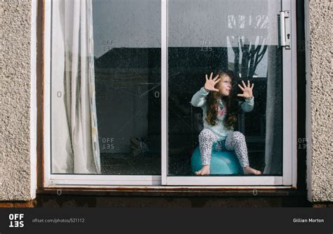 Girl Pressing Hands On Glass Door On A Rainy Day Stock Photo Offset