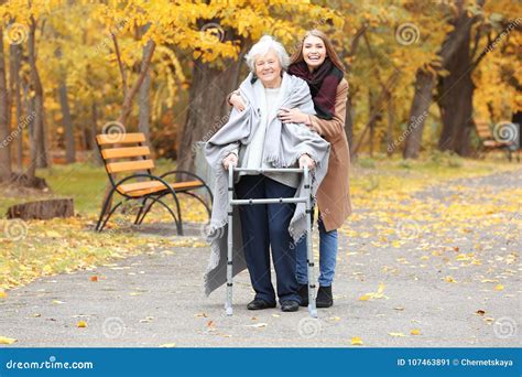 Senior Woman With Walking Frame And Young Caregiver Stock Image Image