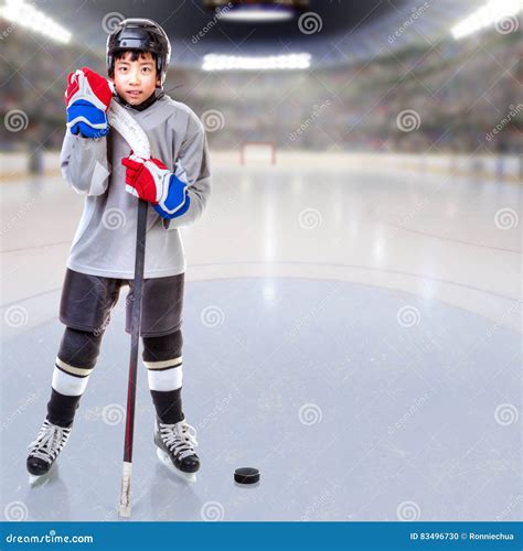 Junior Ice Hockey Player Posing In Arena Stock Illustration