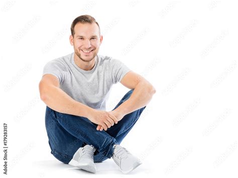 Man Sitting With His Legs Crossed Smiling Guy Stock Photo Adobe Stock
