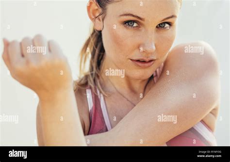 close up of a fitness woman doing stretching exercises woman in fitness wear stretching her