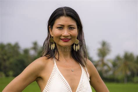 Outdoors Holidays Portrait Of Attractive And Happy Middle Aged Asian Korean Woman In White Dress