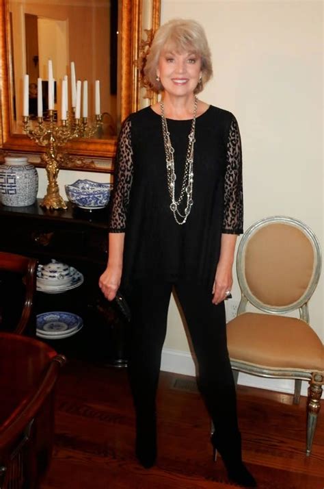 An Older Woman Standing In Front Of A Table With Plates On It And A