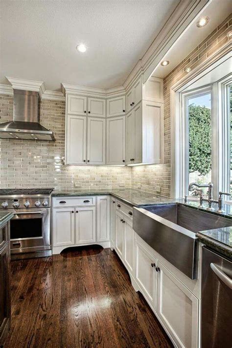 Jul 16, 2020 · 25 gorgeous modern farmhouse and cottage kitchen tile ideas. Ivory cabinets dark floor | Classic white kitchen, Kitchen ...