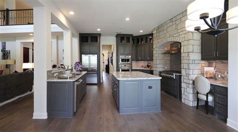 The warmth of the orange accents is tempered by the cool blue and brick tones. Choose flooring that complements cabinet color - Burrows Cabinets - central Texas builder-direct ...