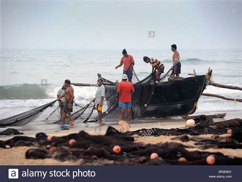 Indian Fishermen Repairing Their Nets On The Beach Goa India Stock