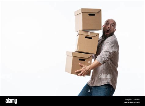 Young Man Carrying And Dropping His Stack Of Moving Boxes Stock Photo