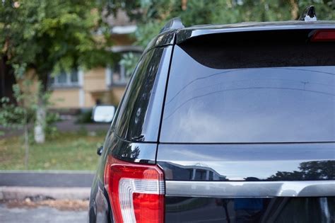 Premium Photo | Back window of white car parked on the street in summer sunny day, rear view ...