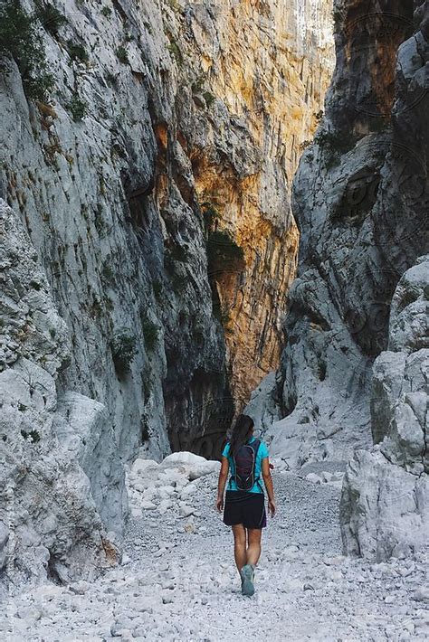 Tanned Woman Hiking At Su Gorroppu Canyon Sardinia Italy By Sky Blue