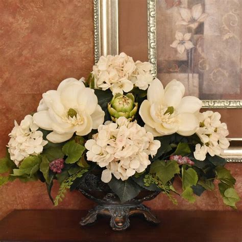 cream magnolia and hydrangea silk floral centerpiecein embossed oval vase silk floral