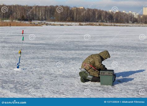 Man Ice Fishing On A Frozen Lake Editorial Stock Image Image Of