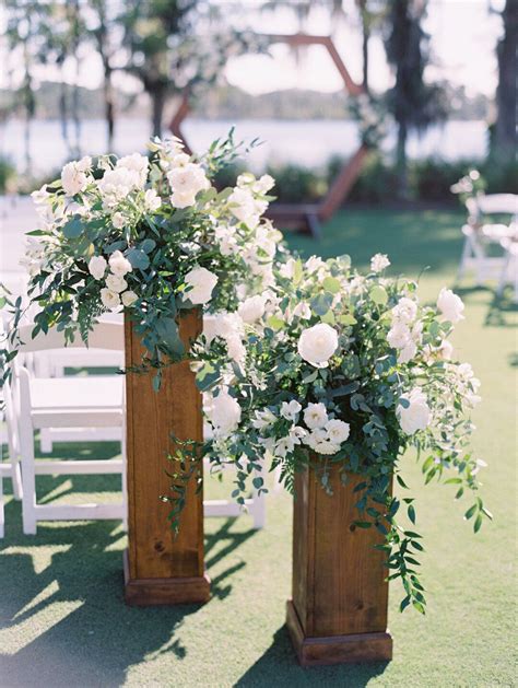 White And Green Floral Altar Pieces In A Garden Style Atop Of Natural