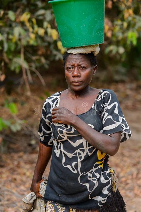 unidentified local woman carries a bucket on her head in a vill editorial stock image image of