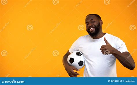 Attractive Afro American Man Holding Soccer Ball And Showing Thumbs Up