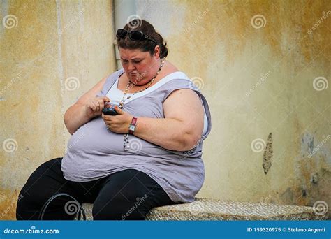Overweight Woman Eats At Buffet Editorial Photo