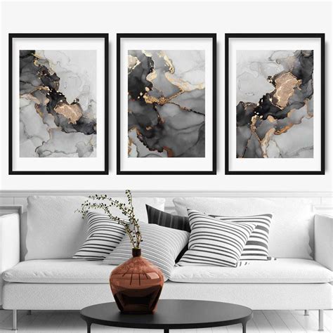 Stunning gold aluminum frame adds a sharp accent to the artwork's aesthetics. Set of 3 Abstract Art Prints of Paintings Black Grey and Gold - Artze Wall Art