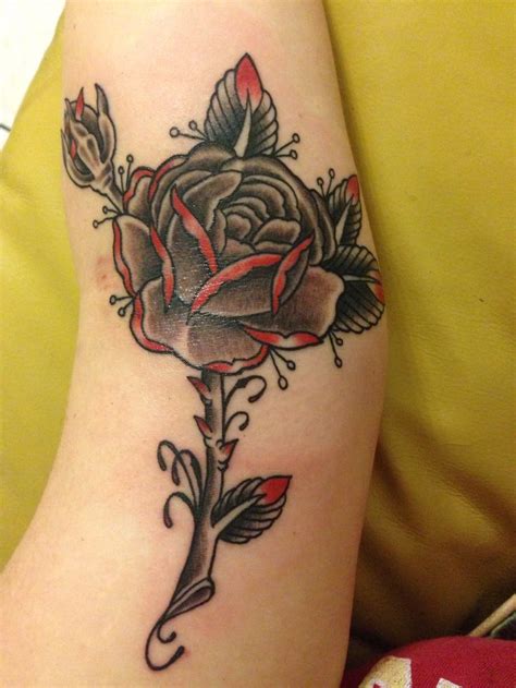 A tattoo like this is perfect for nature lovers as you have both the flower and insect. Black & grey with red rose tattoo done at Kreepy Tiki ...