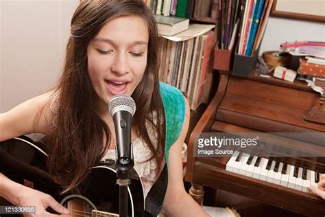 Girl Singing And Playing Piano Photos And Premium High Res Pictures