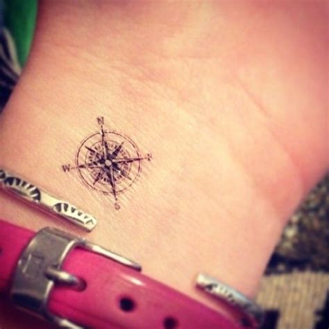 A clock and a compass together can serve as a big reminder that we have limited time in our lives to get where we're going. Pretty small wrist compass tattoo on arm