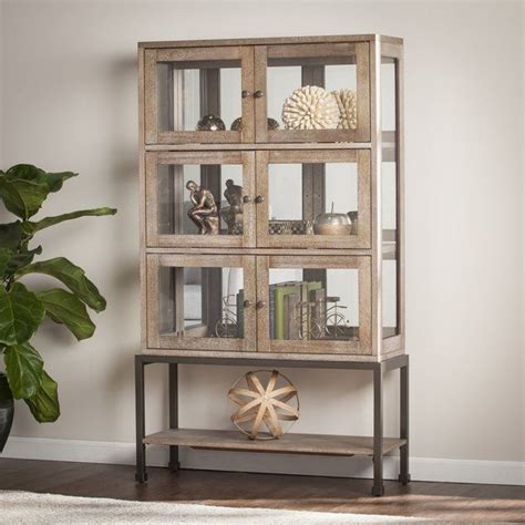 A short curio cabinet display case looks great in any room with a wall mirror above it. Pantin Lighted Curio Cabinet | Living room glass cabinet ...