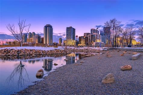 Downtown Calgary Skyline Reflecting Into A Park Lake Stock Photo
