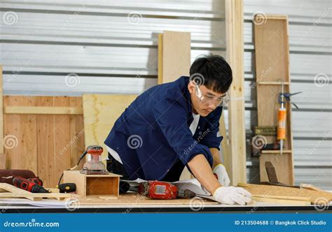 Young Asian Man Working in Carpenter Room. DIY and Handyman Concept
