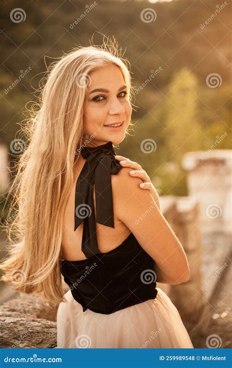 blonde long hair nature summer happy adult girl with long blond hair developing in the wind in