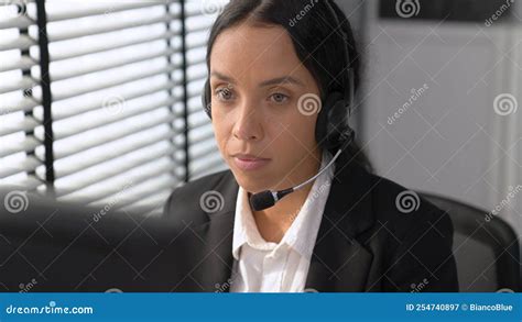 Competent Female Operator Working On Computer And While Talking With