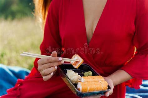 Close Up Sushi Set Attractive Girl In Red Dress Holds Sushi With