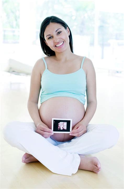 Pregnant Woman Holding Her Baby Scan Photograph By Ian Hooton Science