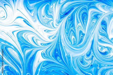 Blue And White Paint Mixing Making Swirls Background Stock Photo