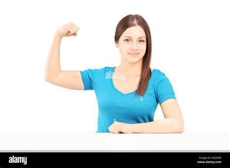 A Young Smiling Woman Showing Her Bicep Muscle Isolated On White