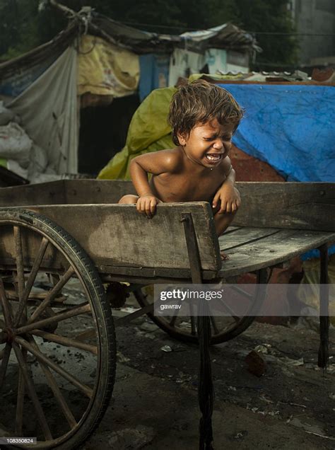 Poor Hungry Child Sitting On A Cart And Crying Loudly High Res Stock