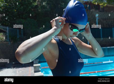Young Female Swimmer Wearing Swim Goggle At Swimming Pool Stock Photo