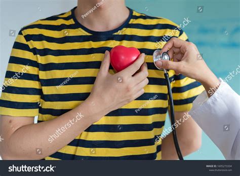 Doctor Using Stethoscope Listen Heart Beat Sound From Red Heart Plastic