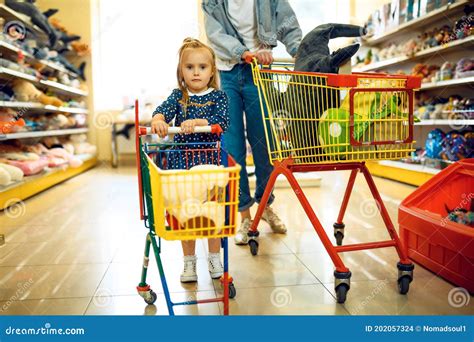 Mother And Little Girl With Carts In Kid`s Store Stock Photo Image Of