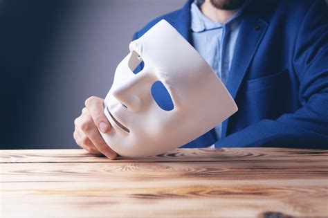 Premium Photo Businessman Holding White Mask In His Hand