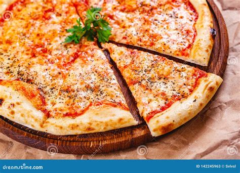 Italian Pizza Margherita With Tomatoes And Mozzarella Cheese On Wooden