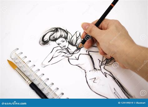 Close Up Of An Illustrator Hand Drawing A Fashion Sketch Stock Image