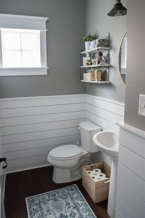 A White Toilet Sitting Next To A Sink In A Bathroom Under A Window On