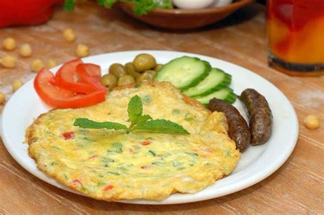 A colorful serving of casserole on a white plate with a baking dish in the background The top 5 Middle Eastern brunch restaurants in Toronto