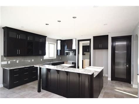 This kitchen only using two basic colors, it gives another. black kitchen cabinets with grey walls - Google Search ...