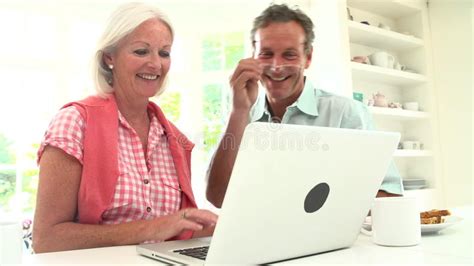 Middle Aged Couple Looking At Laptop Over Breakfast Stock Video Video