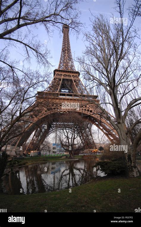A View Of The Eiffel Tower Overlooking The City Of Paris On The River
