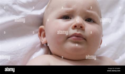 Portrait Of Baby Lying On Bed Stock Photo Alamy