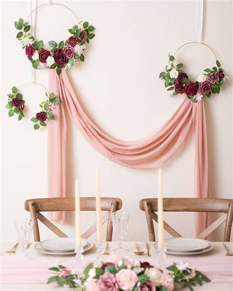 A Vintage Wedding Backdrop Idea With Fabric And Floral Hoops Hangin