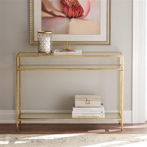 Your coffee table is an important touch for anchoring your living ensemble with a handy surface area that accents your room's style. Pardon Our Dust | Console table decorating, Glass console table, Console table styling